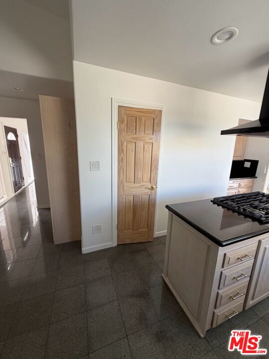 3900 Castlerock Road Malibu, CA 90265 - Photo 31 of 52 a kitchen with granite countertop a stove and a refrigerator