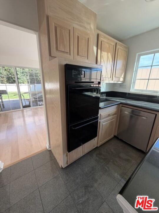 3900 Castlerock Road Malibu, CA 90265 - Photo 39 of 52 a kitchen with granite countertop a stove a sink and a microwave
