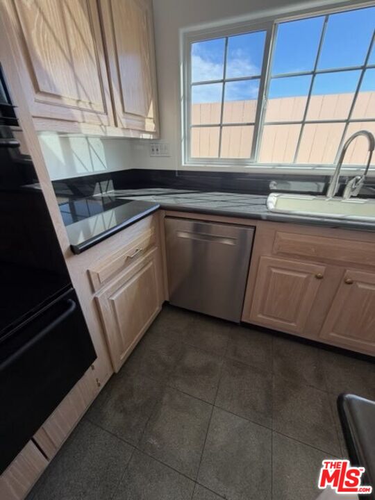 3900 Castlerock Road Malibu, CA 90265 - Photo 40 of 52 a kitchen with granite countertop a sink and a stove