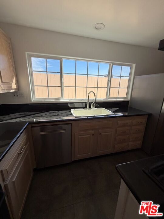 3900 Castlerock Road Malibu, CA 90265 - Photo 42 of 52 a kitchen with a sink a window and cabinets