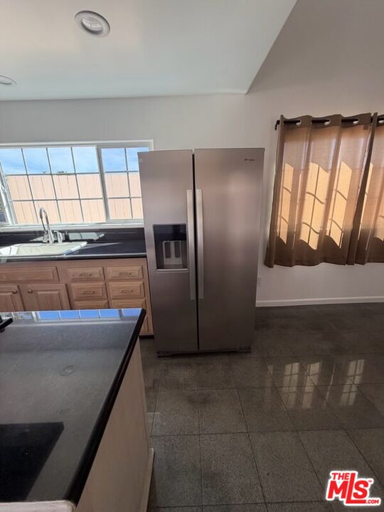 3900 Castlerock Road Malibu, CA 90265 - Photo 43 of 52 a kitchen with stainless steel appliances granite countertop a sink and a refrigerator