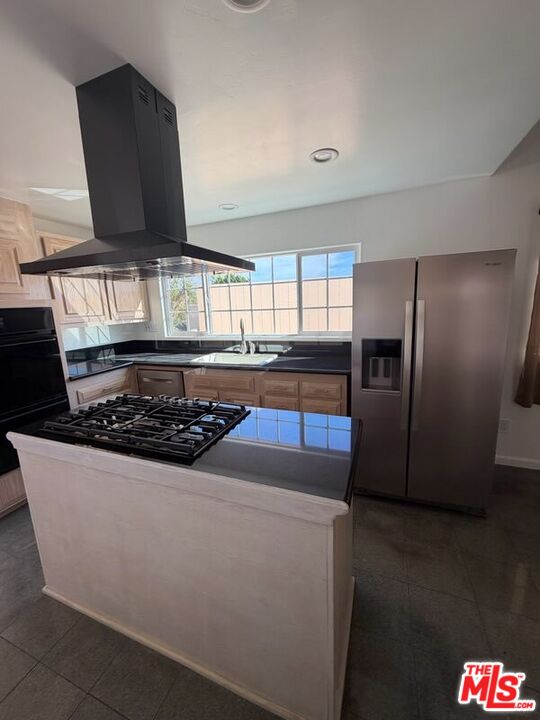 3900 Castlerock Road Malibu, CA 90265 - Photo 44 of 52 a kitchen with stainless steel appliances a stove a refrigerator and a sink
