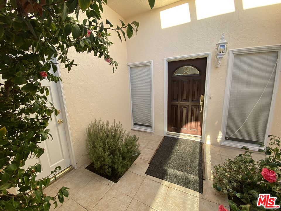 3900 Castlerock Road Malibu, CA 90265 - Photo 5 of 52 a view of a front door and a potted plant
