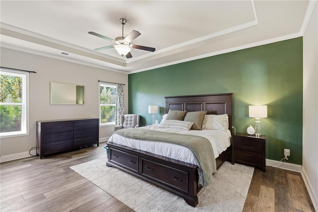 47 Violet Lane Dallas, GA 30132 - Photo 14 of 27 a bedroom with a large bed and a chandelier