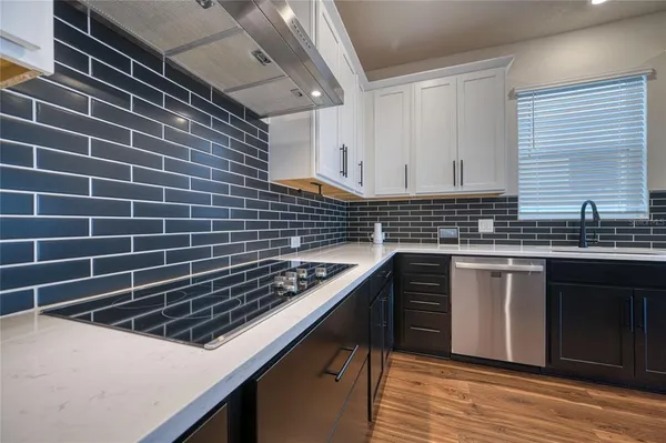 a kitchen with a sink a stove and cabinets