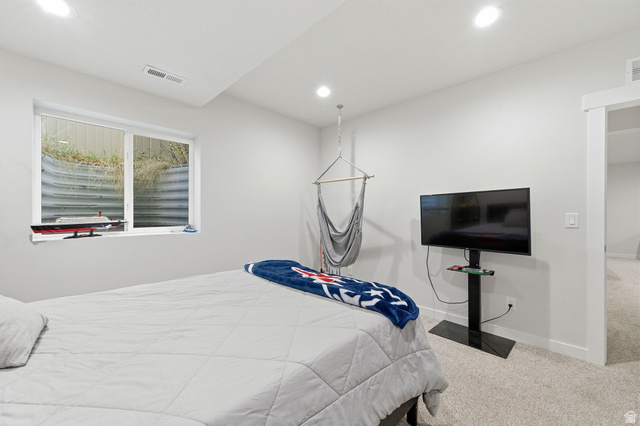 1038 South Old Towne Road Layton, UT 84041 - Photo 20 of 39 Carpeted room featuring a large window with a window well, recessed lighting, white walls, and a built-in wall niche