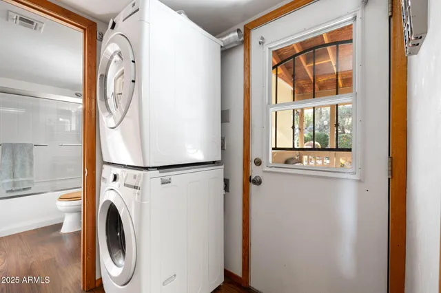 a spacious bedroom with a bed a bookshelf and a chandelier