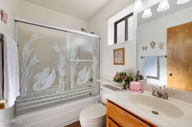 a en suite bathroom with a double vanity sink a mirror and a toilet