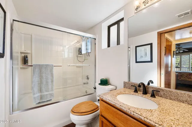 a bedroom with a bed couch and window