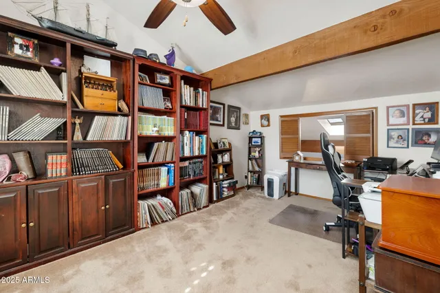 a living room with furniture workspace and a flat screen tv