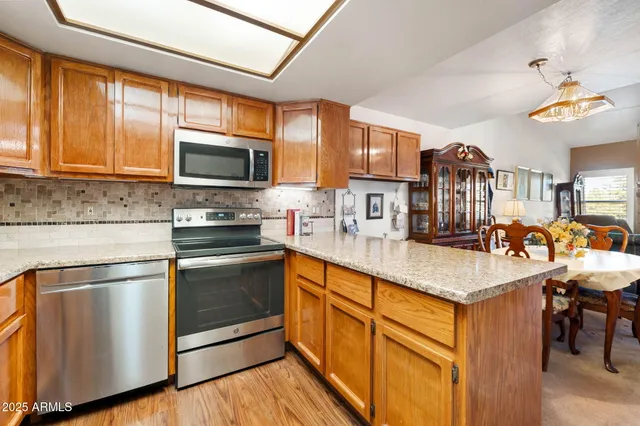 a outdoor dining space with furniture and a chandelier