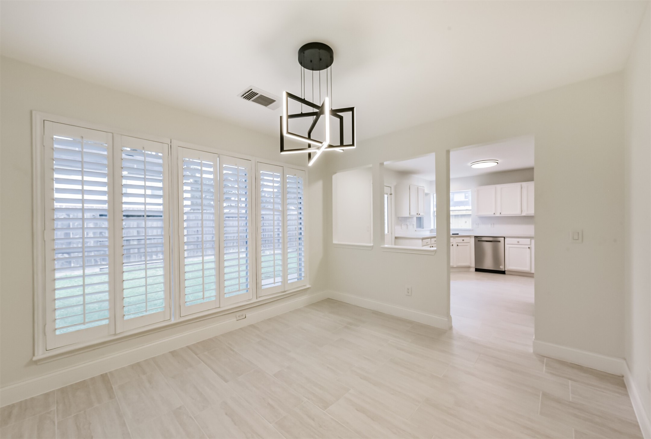 9202 Bayou Bluff Drive Spring, TX 77379 - Photo 9 of 33 Dining room with plantation shutters and modern light fixture.