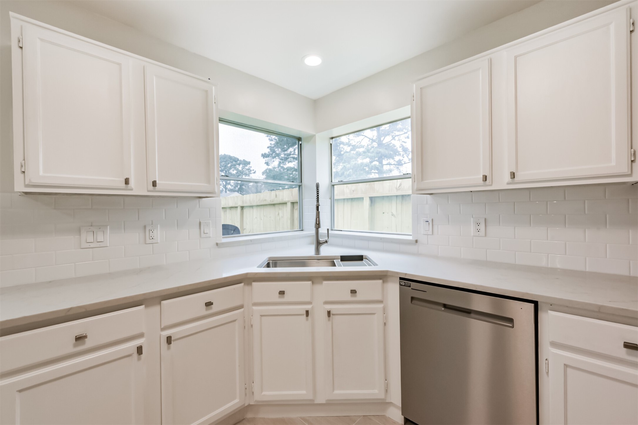 9202 Bayou Bluff Drive Spring, TX 77379 - Photo 13 of 33 a kitchen with white cabinets and a window