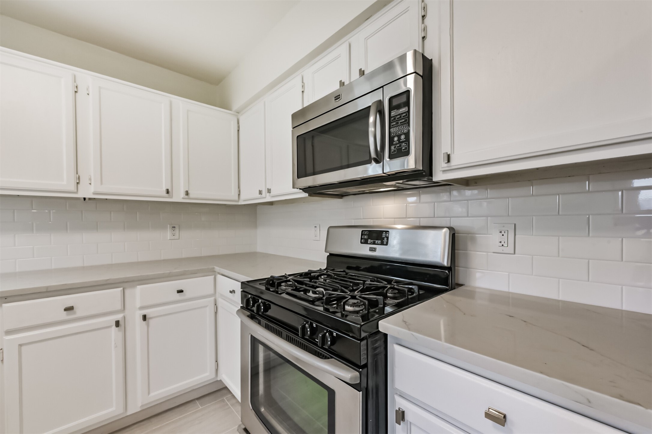 9202 Bayou Bluff Drive Spring, TX 77379 - Photo 14 of 33 a kitchen with stainless steel appliances granite countertop white cabinets and a stove top oven