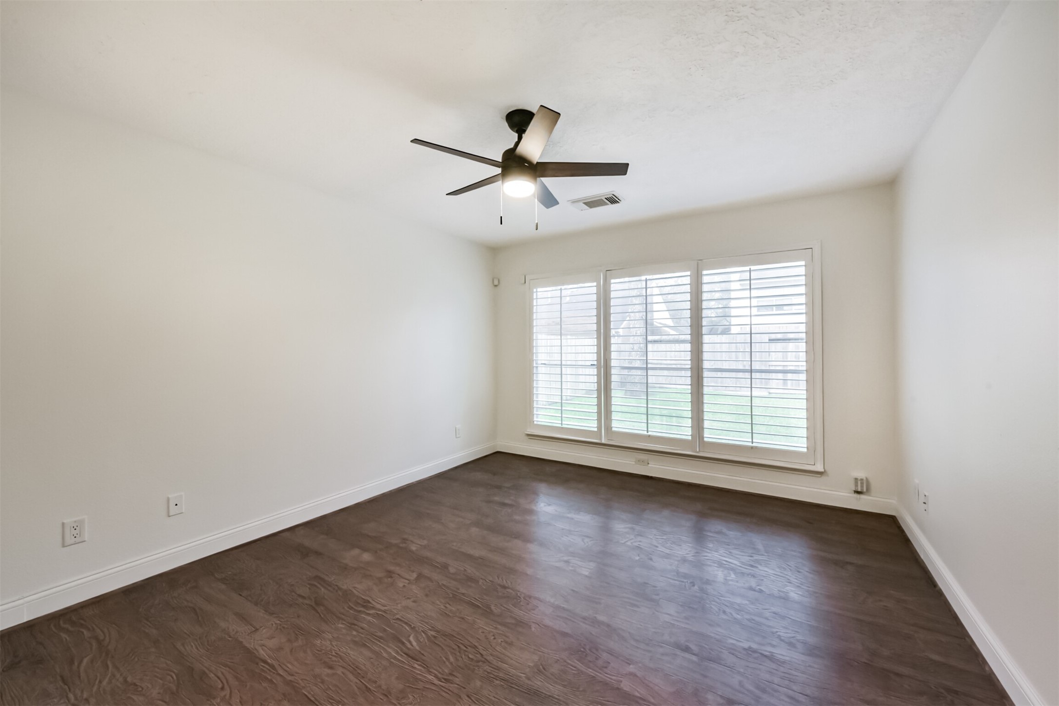 9202 Bayou Bluff Drive Spring, TX 77379 - Photo 16 of 33 an empty room with wooden floor chandelier fan and windows