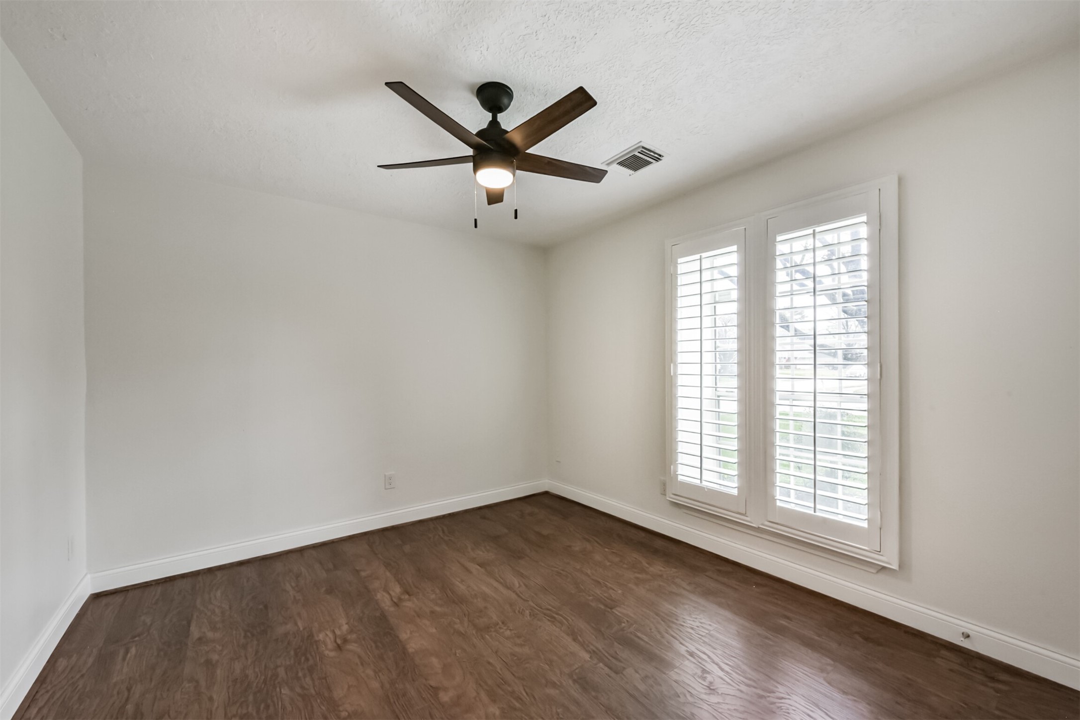 9202 Bayou Bluff Drive Spring, TX 77379 - Photo 22 of 33 a view of empty room with wooden floor and fan