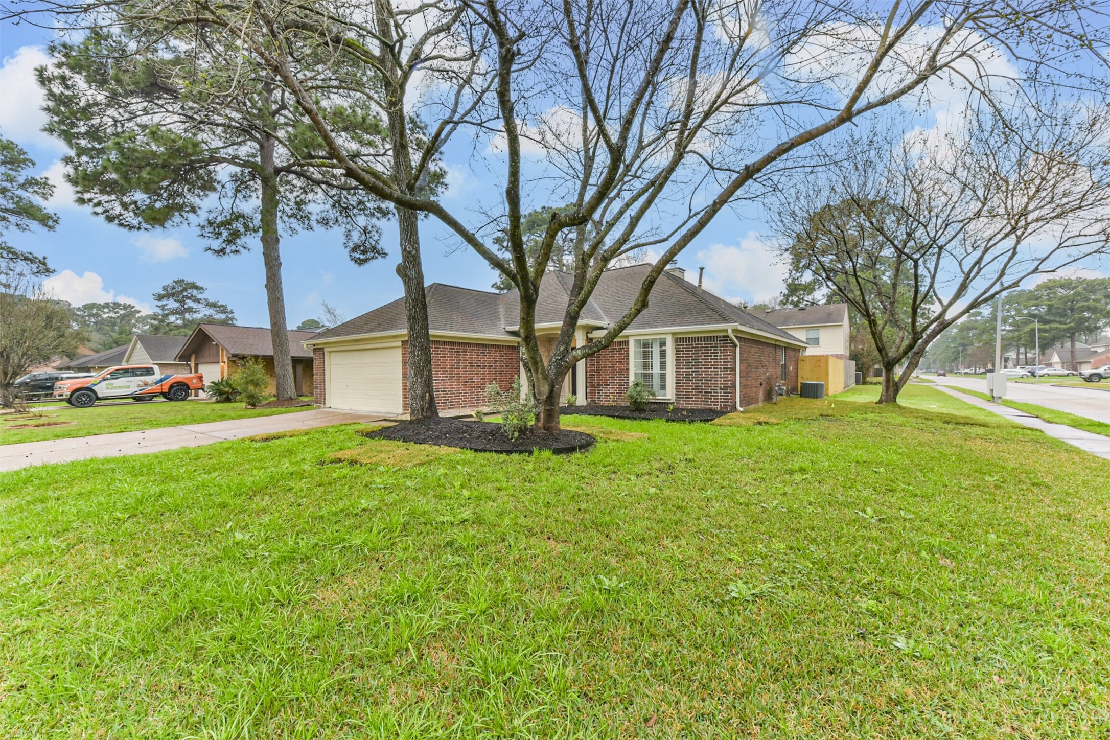 9202 Bayou Bluff Drive Spring, TX 77379 - Photo 4 of 33 a brick house with trees in front of it