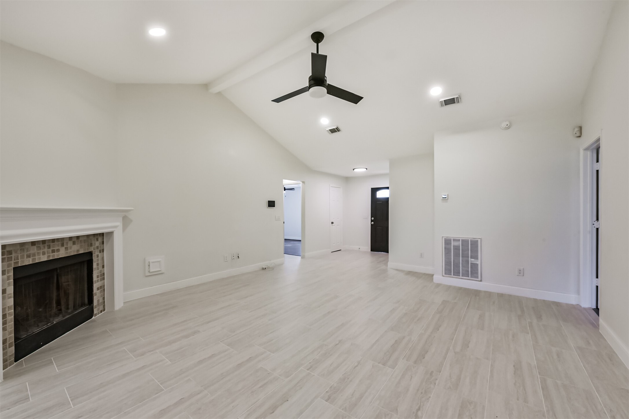 9202 Bayou Bluff Drive Spring, TX 77379 - Photo 8 of 33 a view of an empty room with wooden floor fireplace and a window
