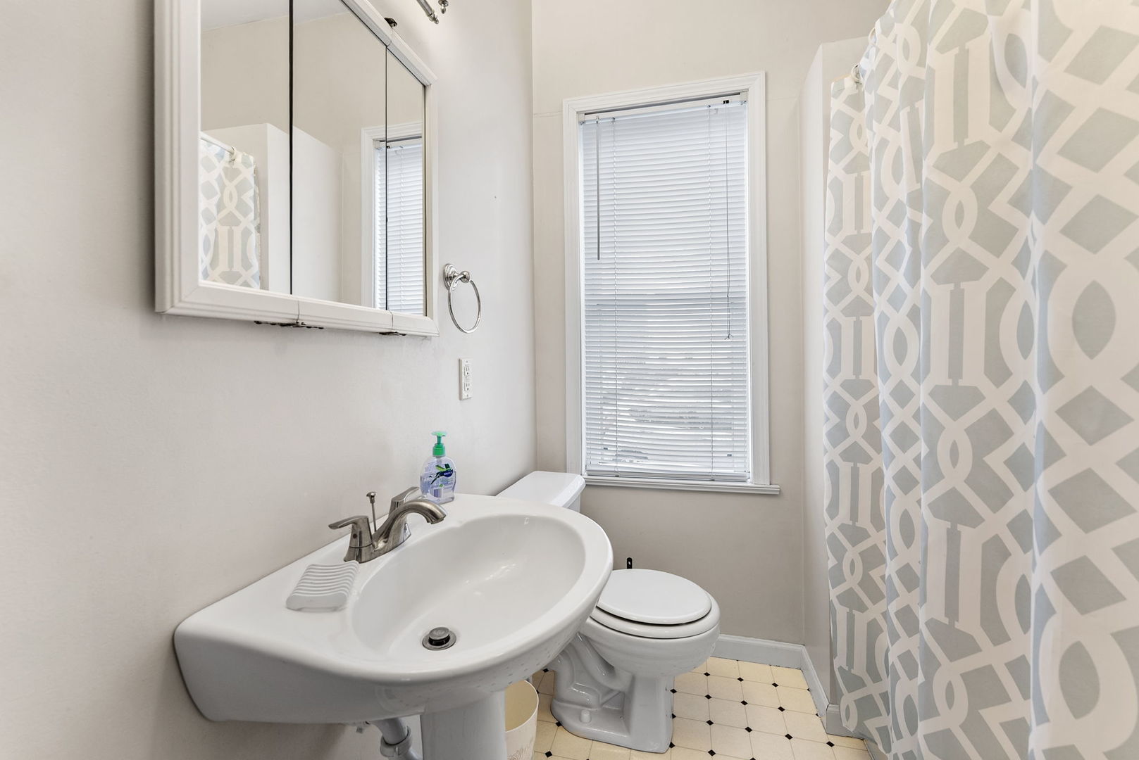 313 1st Avenue Silvis, IL 61282 - Photo 11 of 23 a bathroom with a sink a toilet and a mirror