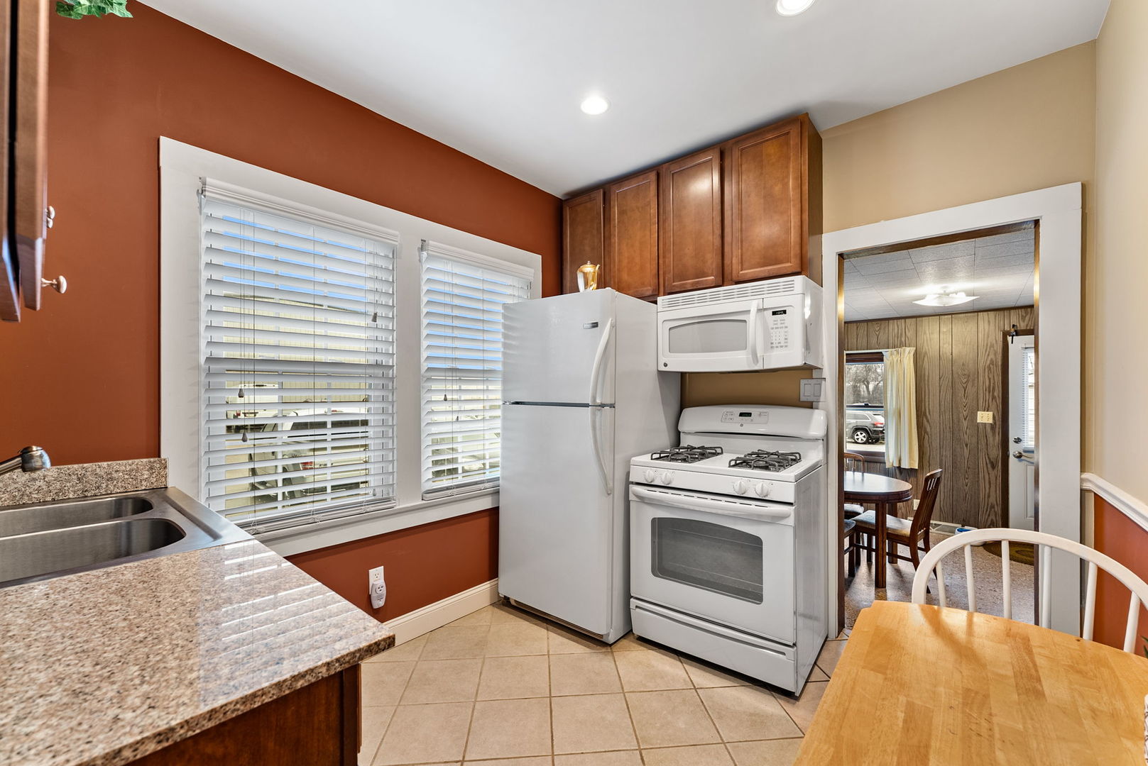 313 1st Avenue Silvis, IL 61282 - Photo 14 of 23 a kitchen with stainless steel appliances granite countertop a stove a refrigerator and a sink