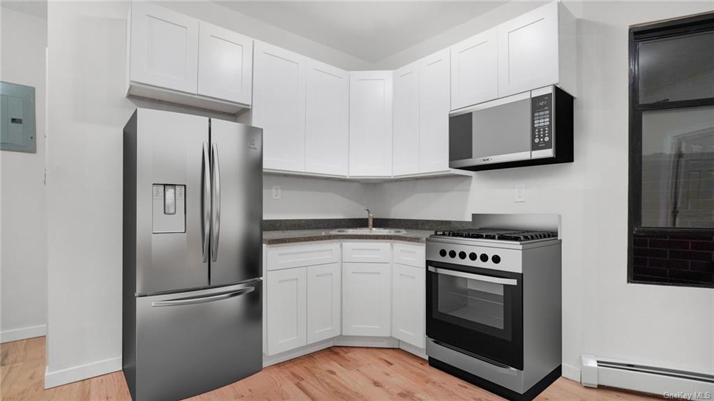 a kitchen with stainless steel appliances a stove a microwave and a refrigerator
