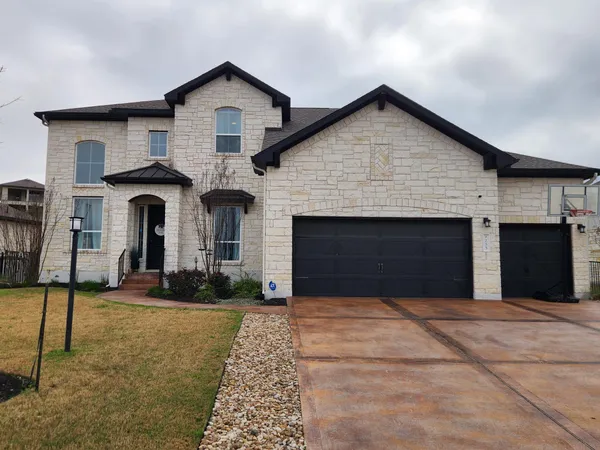 a front view of a house with yard and garage