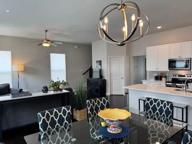 a living room with furniture and a chandelier