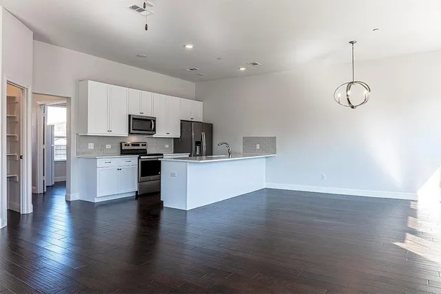 a view of kitchen with sink microwave and stove
