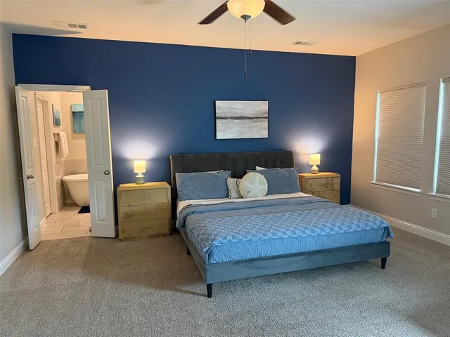 a bedroom with a bed and lamp