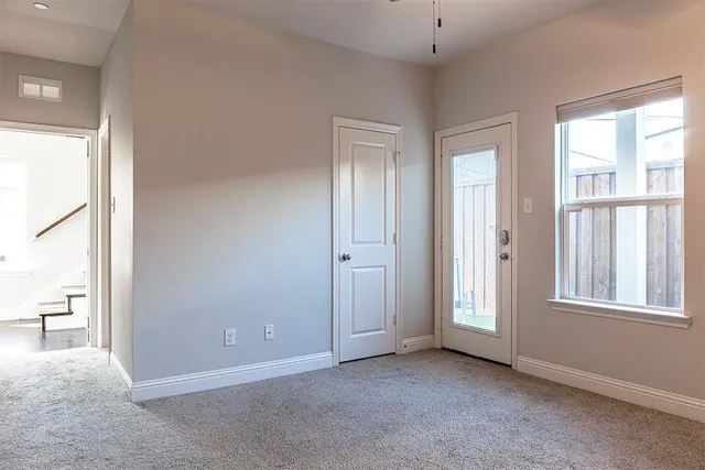 an empty room with windows and closet