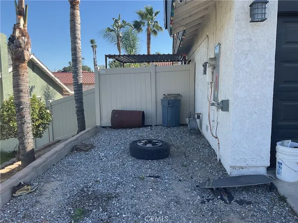a view of a porch with furniture and floor to ceiling window