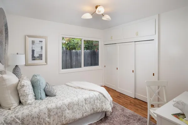 a bedroom with a bed and a window