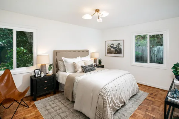 a bedroom with a bed and a large window