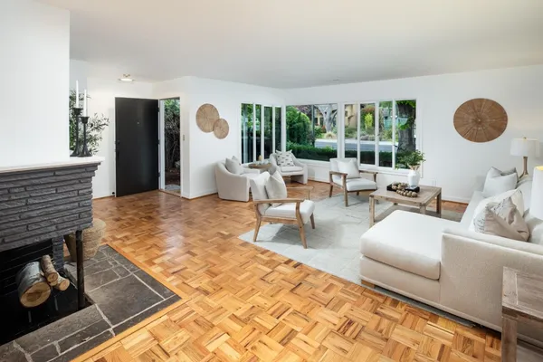 a living room with furniture and a floor to ceiling window