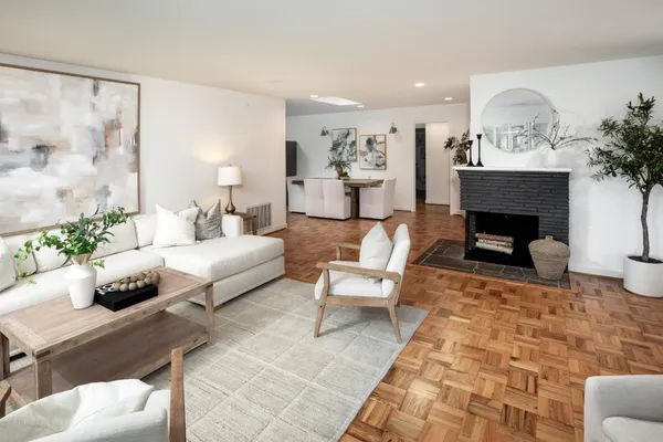 a living room with furniture and a fireplace