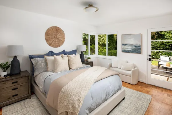 a bed room with a bed mirror and a window