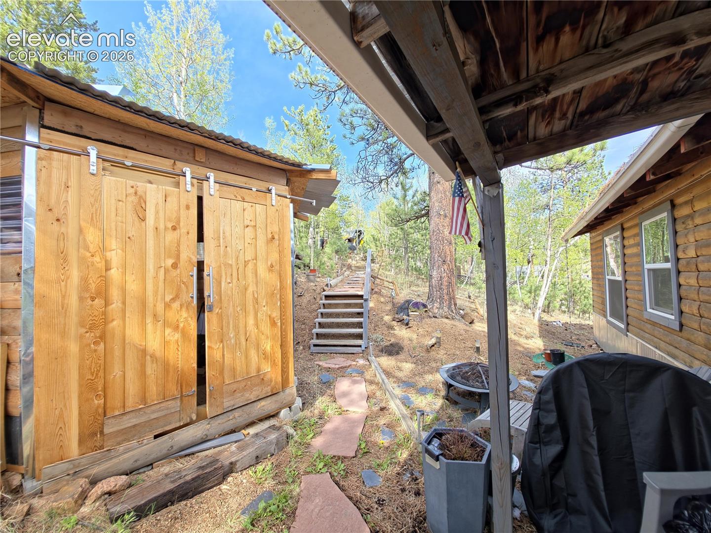 226 Hall Road Bailey, CO 80421 - Photo 2 of 37 Looking up from front door w/ view of heated shed w/ electric