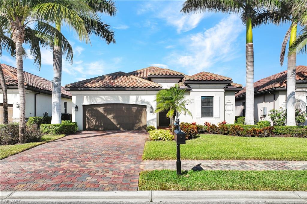 2786 Aviamar Circle Naples, FL 34114 - Photo 1 of 1 a front view of a house with a garden and palm trees