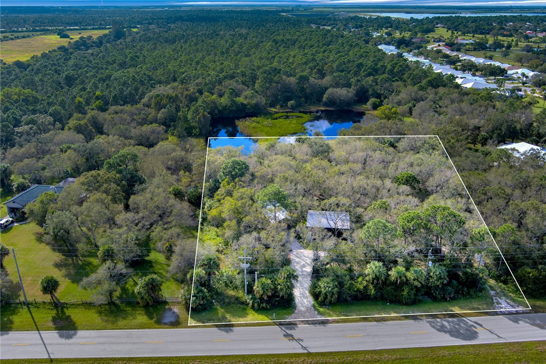 2465 Johnston Road Fort Pierce, FL 34951 - Photo 1 of 17 an aerial view of a house with a yard