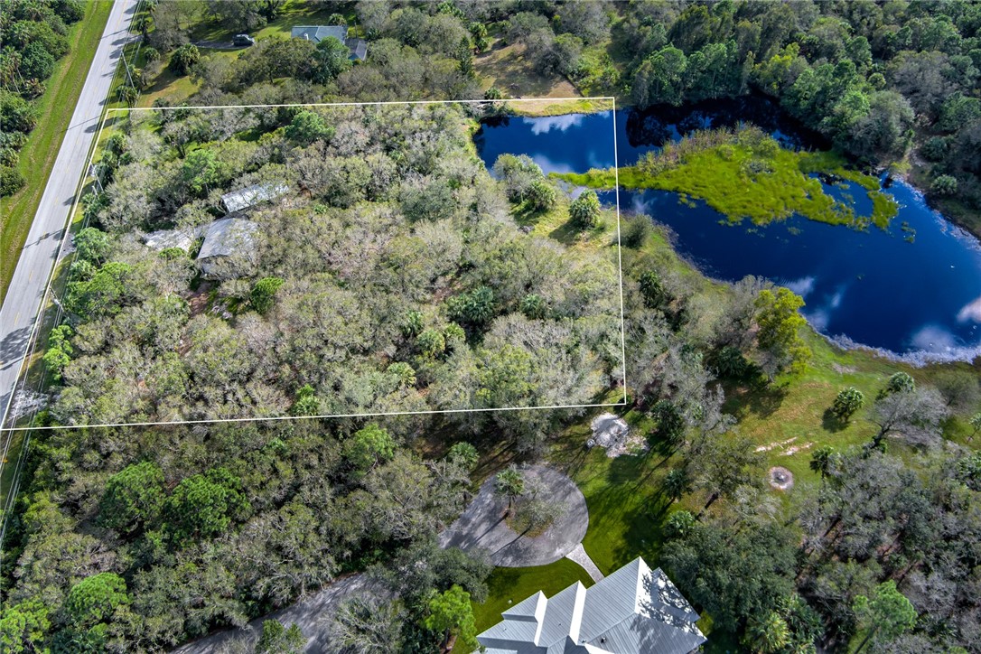 2465 Johnston Road Fort Pierce, FL 34951 - Photo 2 of 17 an aerial view of a house with a yard and garden