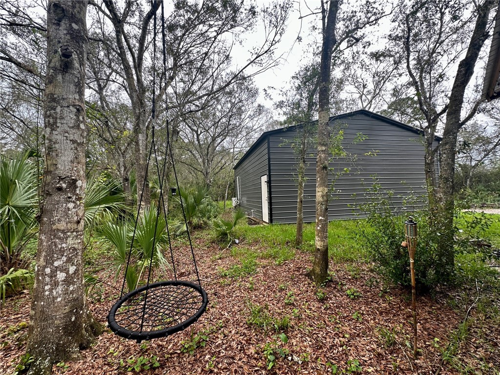 2465 Johnston Road Fort Pierce, FL 34951 - Photo 4 of 17 a backyard of a house with lots of green space