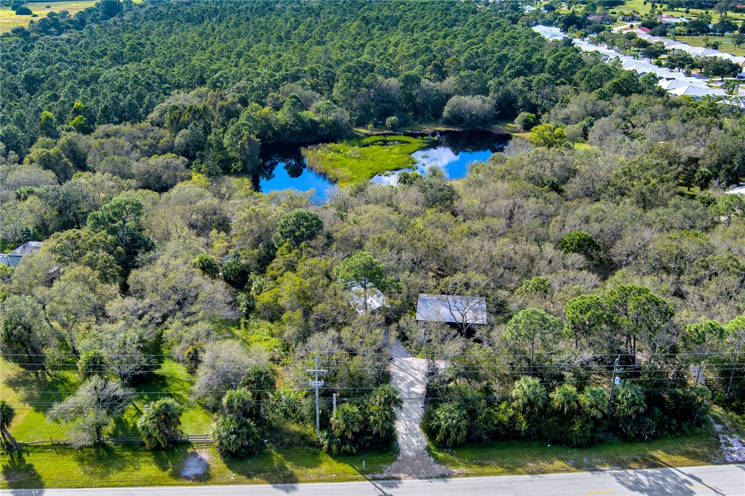 2465 Johnston Road Fort Pierce, FL 34951 - Photo 8 of 17 a aerial view of a house with a yard and lake view