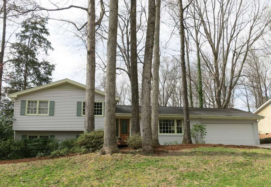 4101 Redington Drive Raleigh, NC 27609 - Photo 1 of 30 Great 4BR/3BA/2246sf split level home w/oversize attached 2-car Garage on wooded .39 acre corner lot in Midtown's desirable Hickory Hills w/swim & tennis available, near Eastgate Park & North Hills shops/dining—walk to Douglas Elem School! Exterior Front