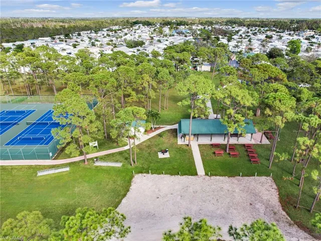 aerial view of a house with a yard and lake view