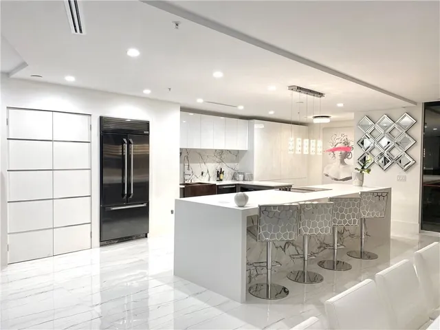 a kitchen with stainless steel appliances kitchen island granite countertop a sink and cabinets