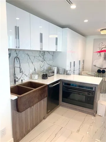 a kitchen with a sink and cabinets