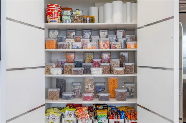 a bedroom with a large bed and a large mirror