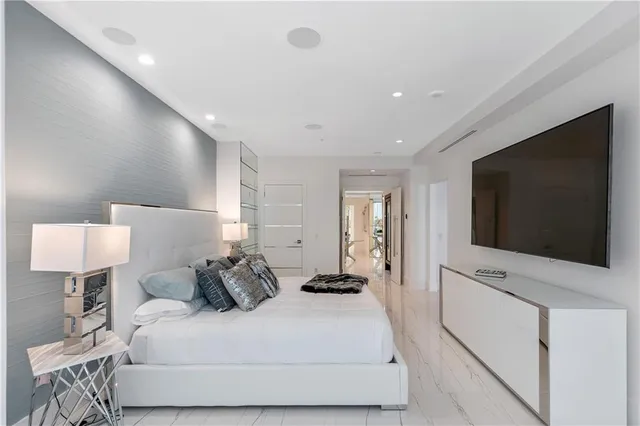 a large bathroom with a glass door shower and sink
