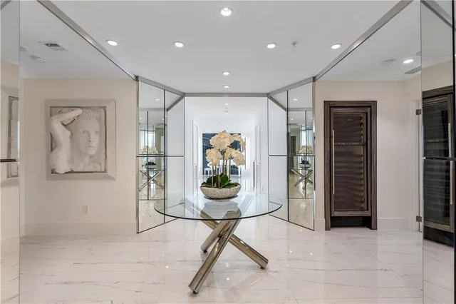 a view of a hallway with table and chairs