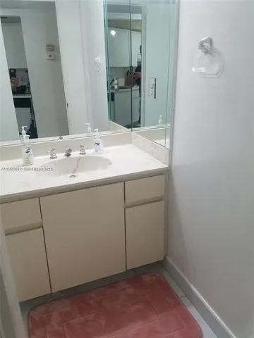 a bathroom with a glass shower door